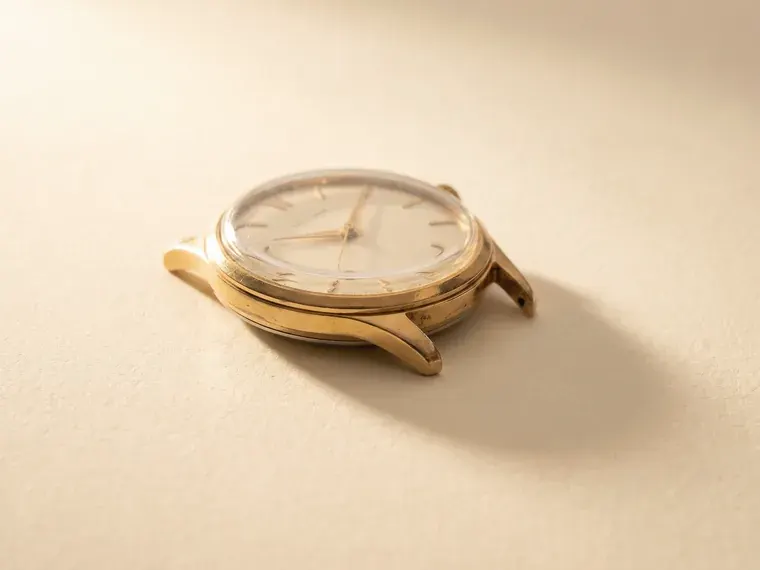 A 1960s gold-cased mechanical wristwatch with the strap removed